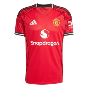Manchester United Home Kit 25/26, front view in red with black and white accents and V-neck collar.